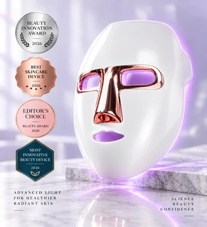 Lumoras LED face mask on a marble surface with rose-gold T-shaped visor and soft purple light