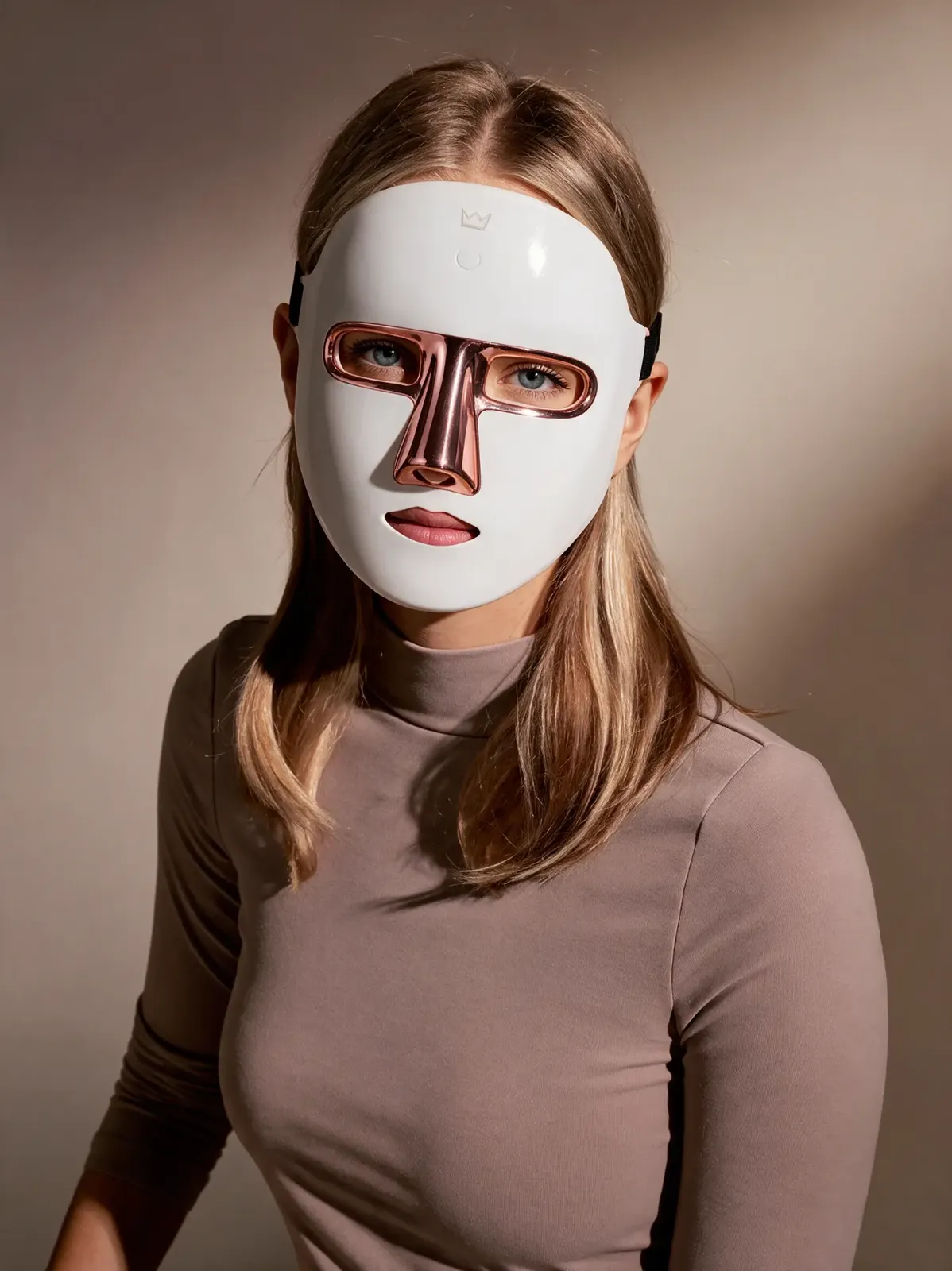 Woman wearing the Lumoras LED face mask in a studio